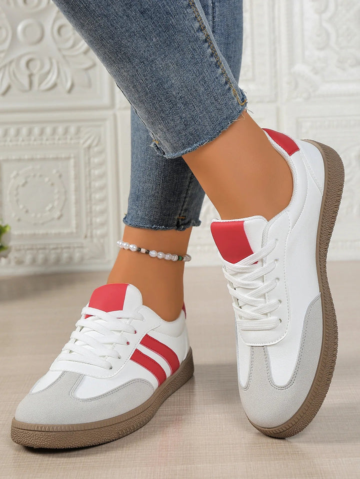 Pair of casual lace-up shoes displayed on a neutral surface