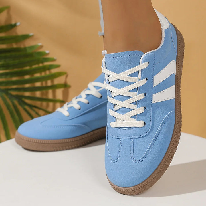 Angled shot of women sneakers highlighting flexible rubber outsole tread