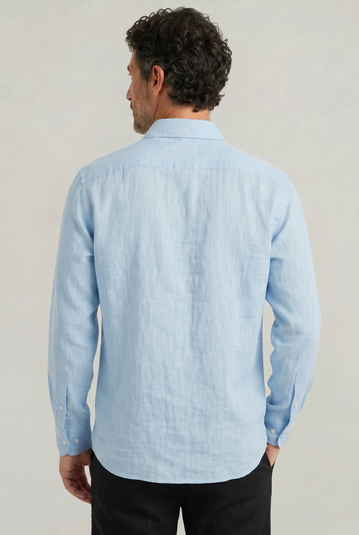 Back view of a man showcasing the regular fit and curved hem of a light blue shirt