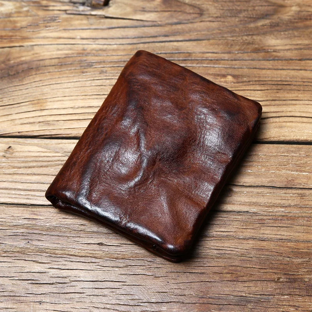 Cognac brown patina leather wallet resting on a rustic wooden table