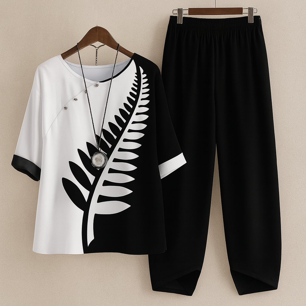 Women's black and white floral two piece set hanging on display