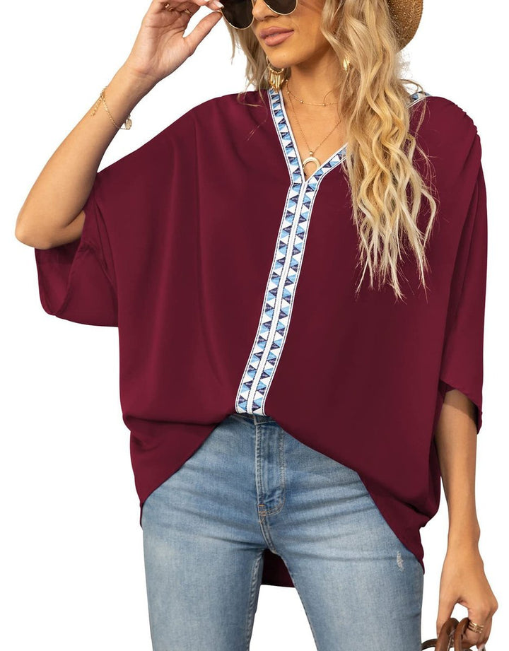 Detailed shot of the short sleeve hem and embroidery pattern on the blouse