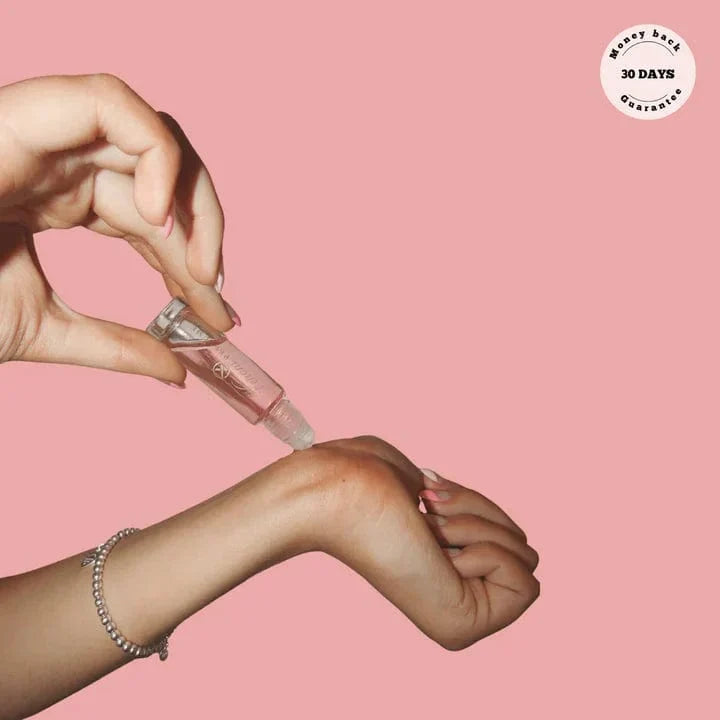 Applying Phero Perfume roll-on fragrance onto wrist