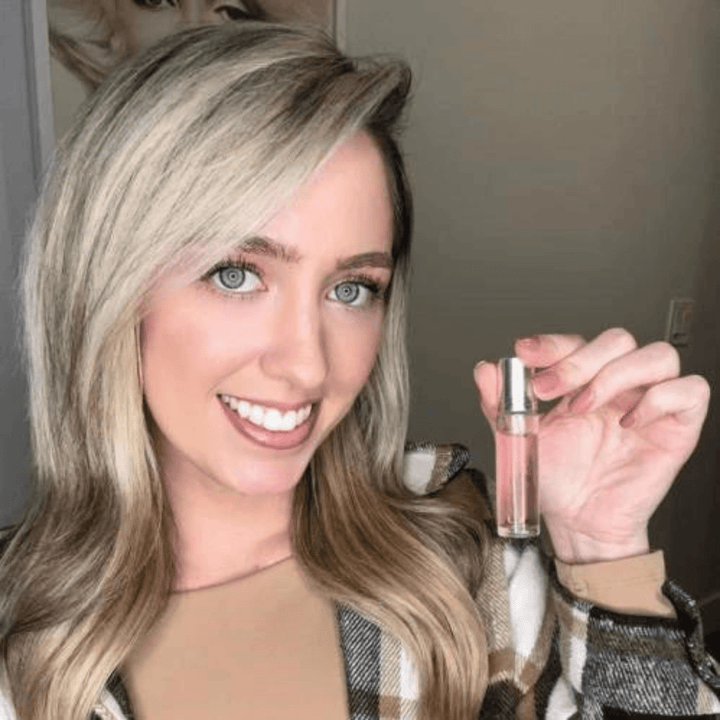 Pocket size attraction scent perfume showing the easy applicator tip