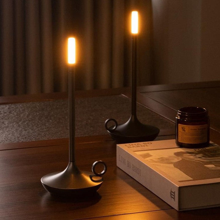 Compact battery-operated LED light fixture providing cozy illumination on a wooden table