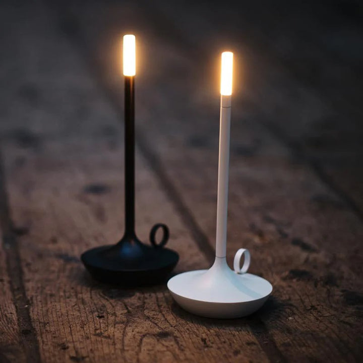 Black and white cordless LED candle lamps side by side