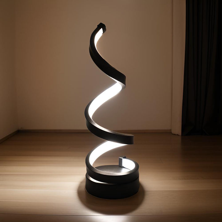 Minimalist desk lamp featuring a unique curved spiral LED design