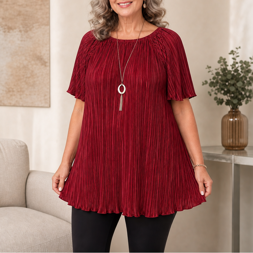 Woman wearing burgundy pleated wide-fit blouse with short sleeves