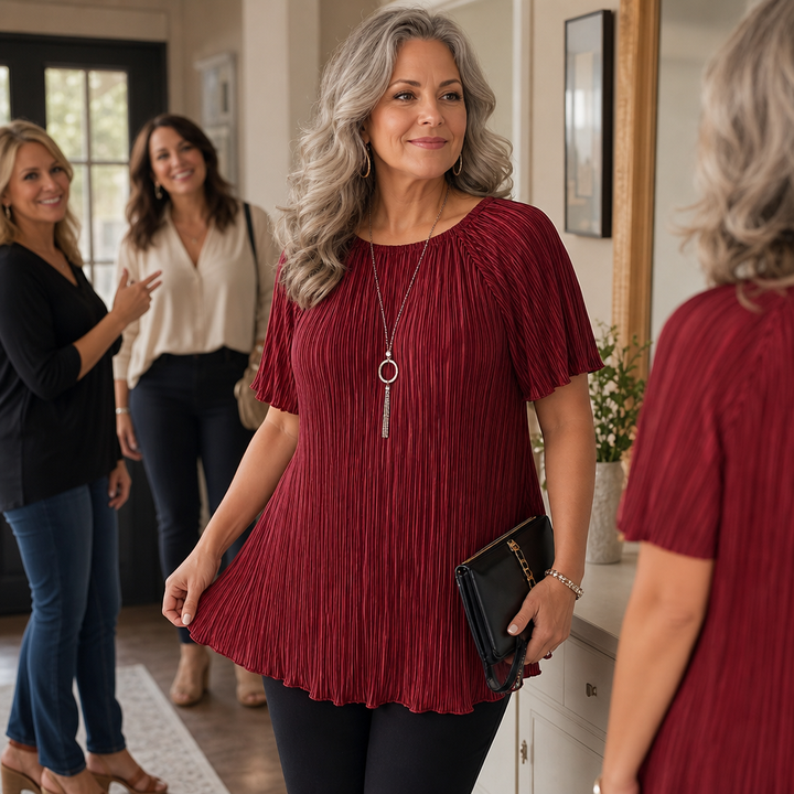 Flat lay of the pleated women's blouse collection in burgundy and black colors