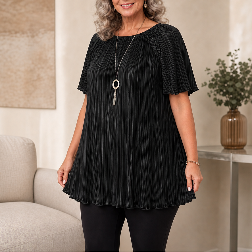 Woman wearing black pleated wide-fit blouse paired with black pants