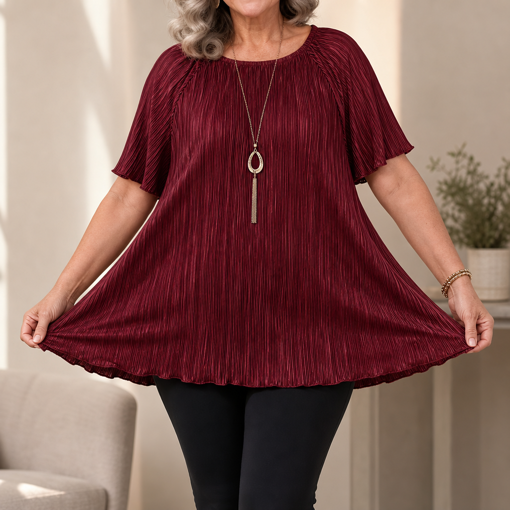 Detail shot of crew neckline and pleated texture on the versatile black top