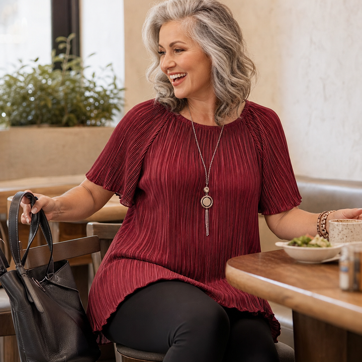 Back view of the flowing wide-fit black shirt for casual everyday wear