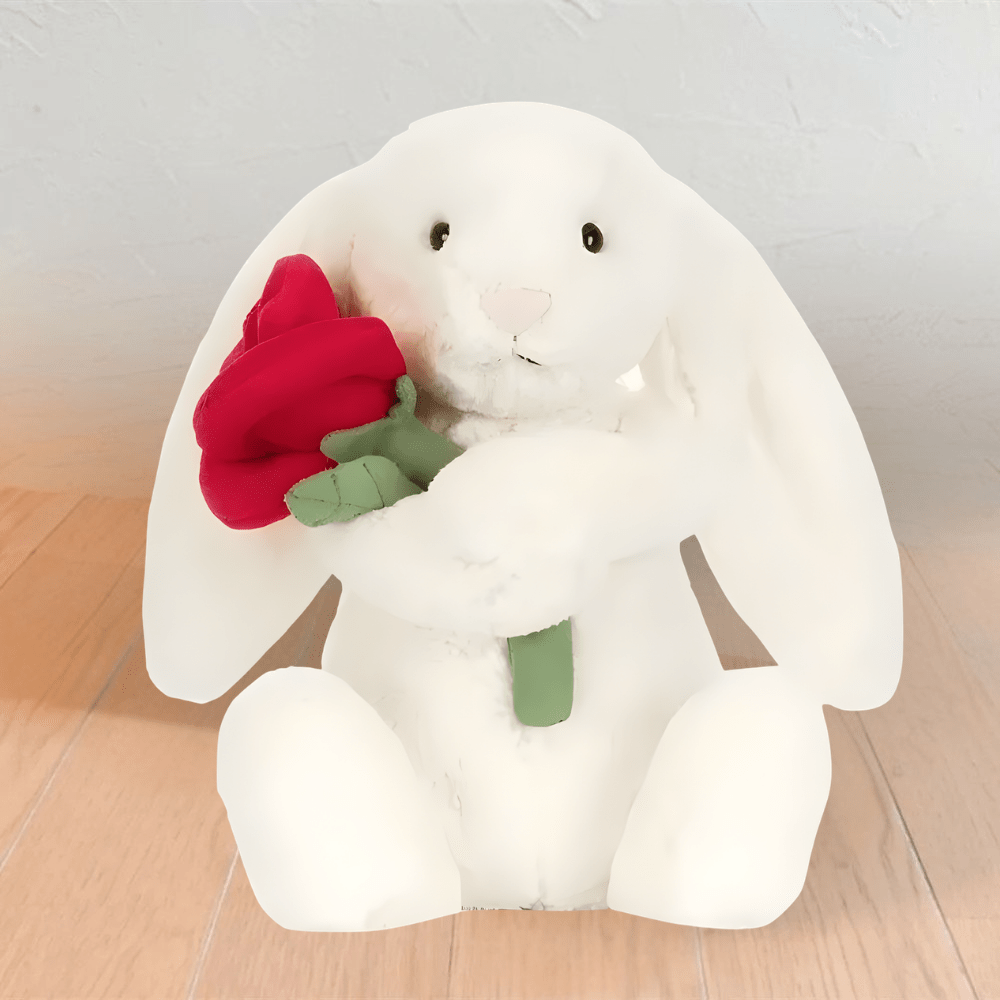 White plush bunny holding a red rose toy