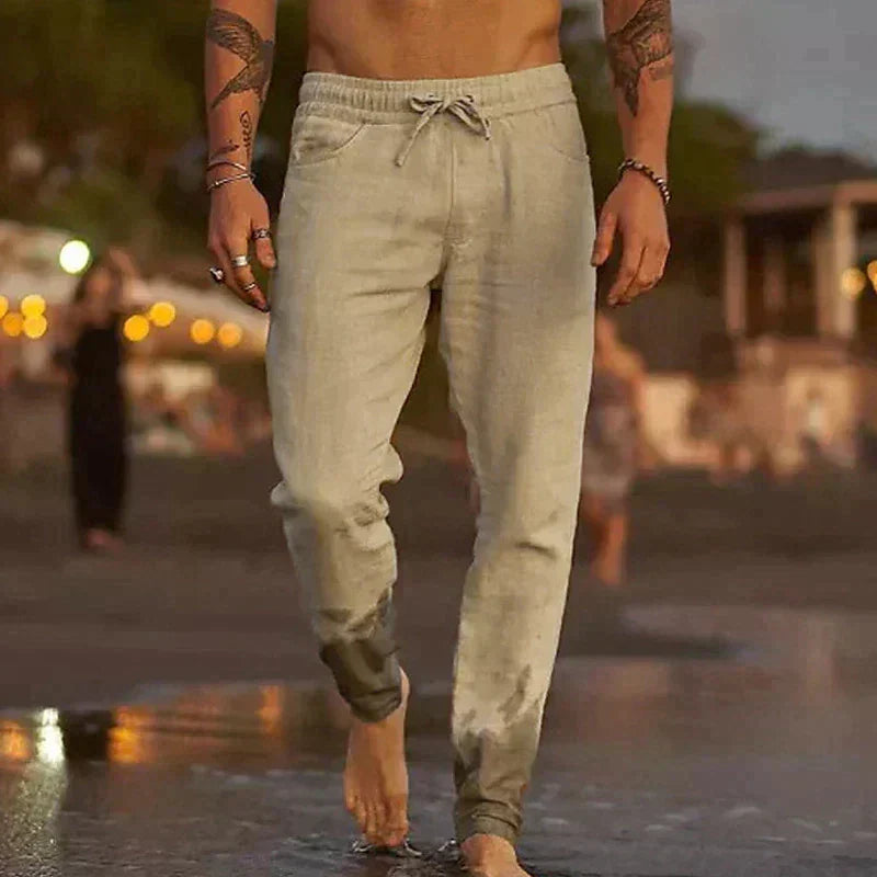 Man wearing lightweight beige casual trousers at the beach