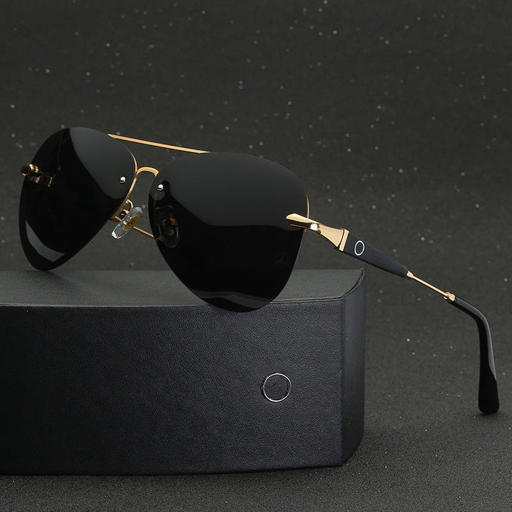 Gold tone polarized aviator sunglasses resting on a dark display box