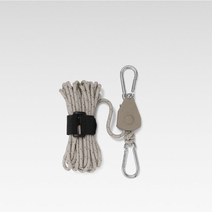 Adjustable camping rope showing secure metal tensioner mechanism