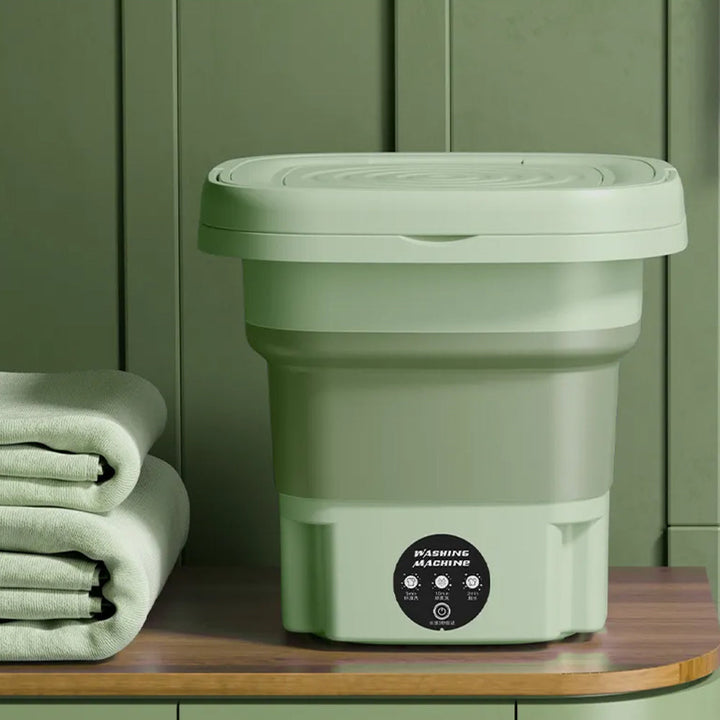 Green portable foldable mini washing machine stored neatly on a shelf