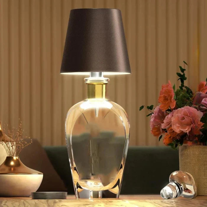 Rechargeable glass bottle lamp with dark brown shade on wooden table