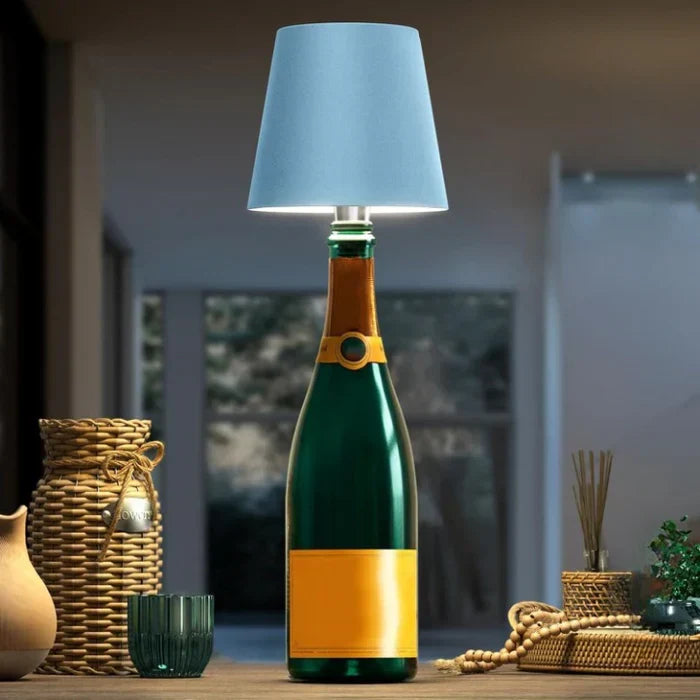 Portable LED bottle lamp with blue shade on green bottle in modern interior