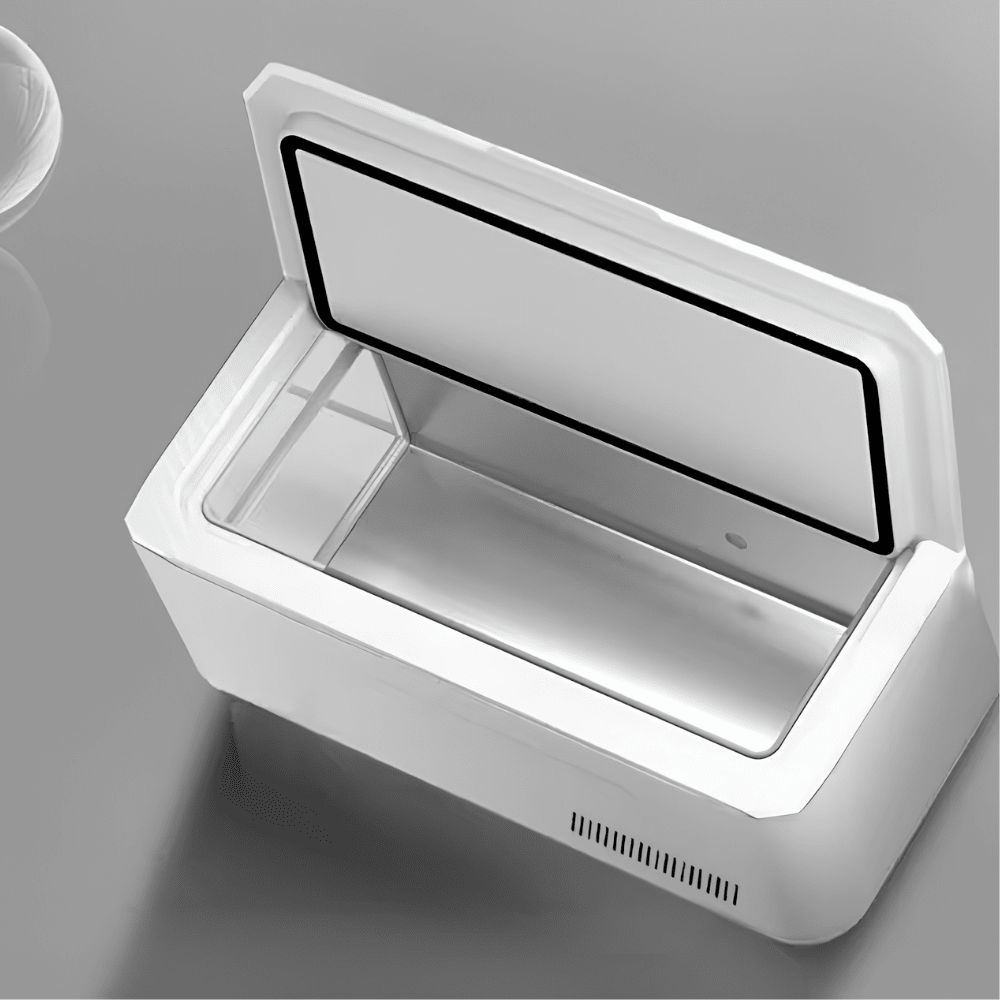 Open white portable mini fridge showing internal stainless steel compartment