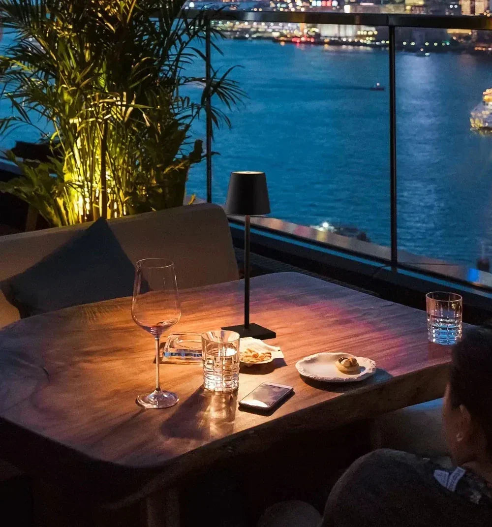 Modern portable lamp casting warm light on a wooden surface