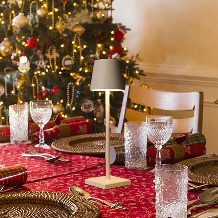 Portable modern aluminium table lamp on a festive dining table