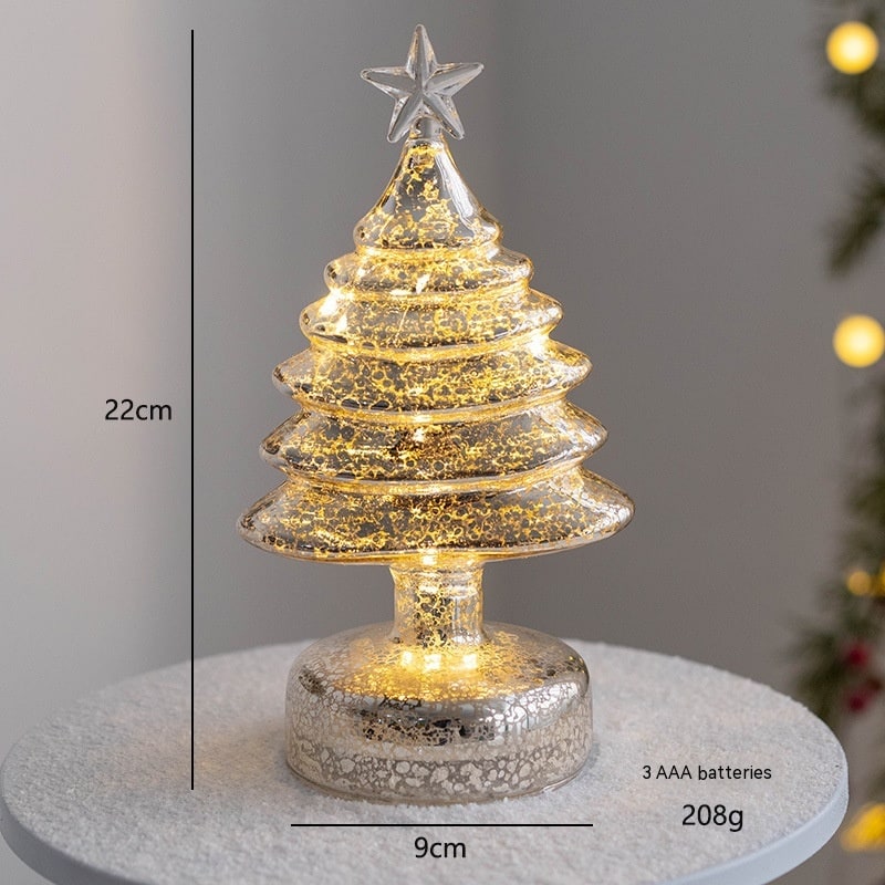 Festive tabletop lighting featuring a glowing glass-style Christmas tree