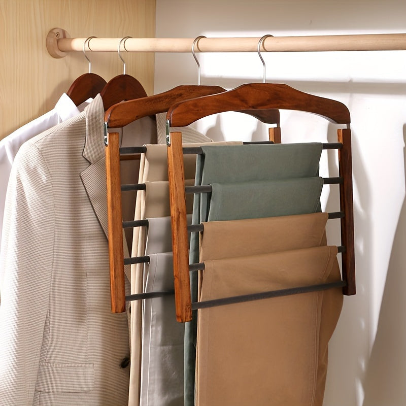 Dark brown wooden multi-bar trouser hanger holding pants in a closet