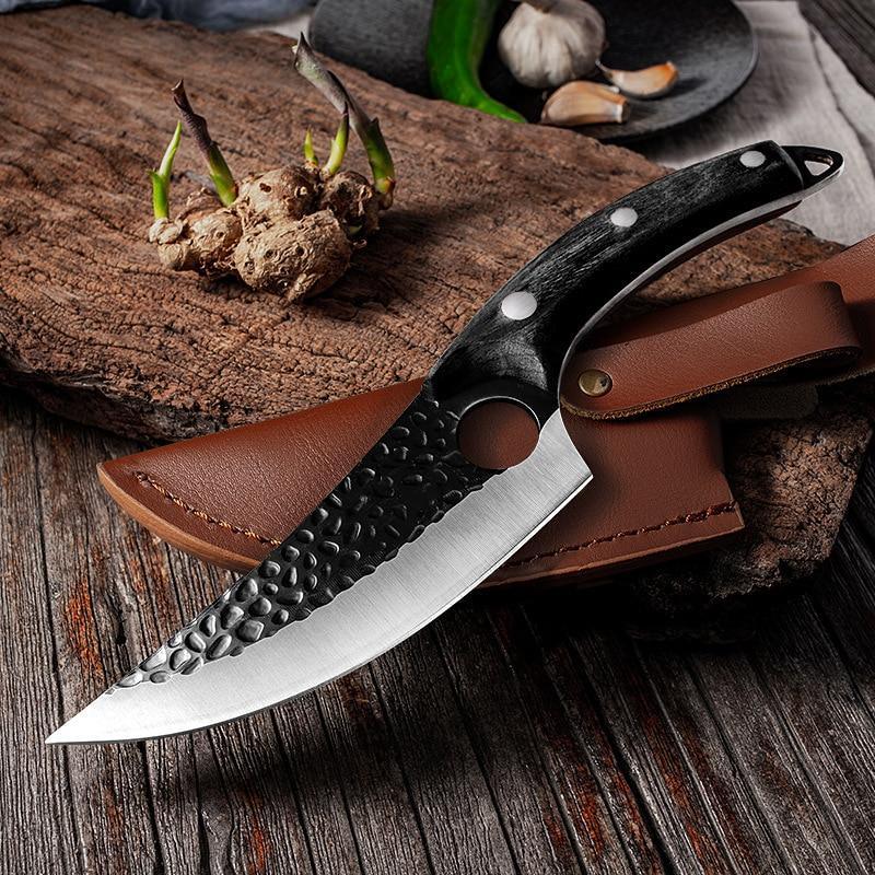 Japanese kitchen knife in black finish resting on a leather sheath