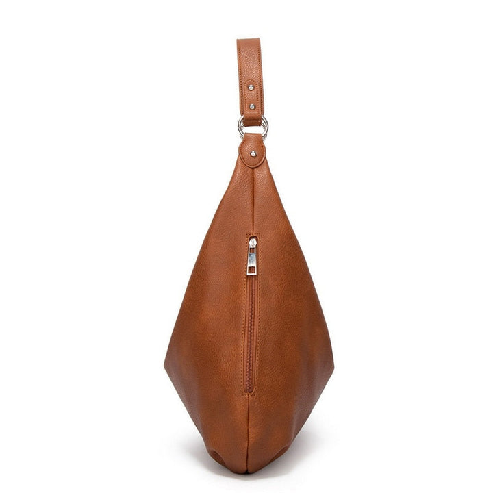 Bottom view of stylish tote bag with protective metal feet studs