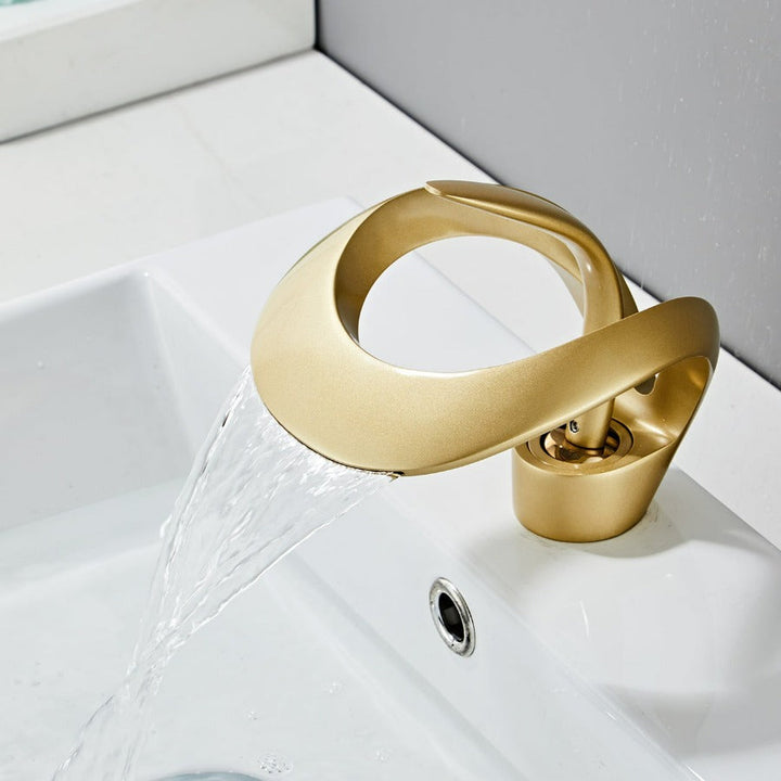 Single handle waterfall faucet mounted on a contemporary bathroom sink