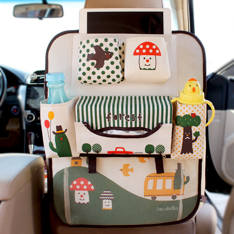 Kids backseat car organizer showing tablet pocket, bottle holders, and cheerful animal motifs mounted on a car seat
