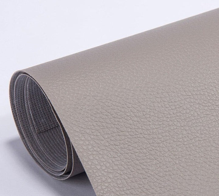 Seamless blend of leather repair patch on a dark brown armchair