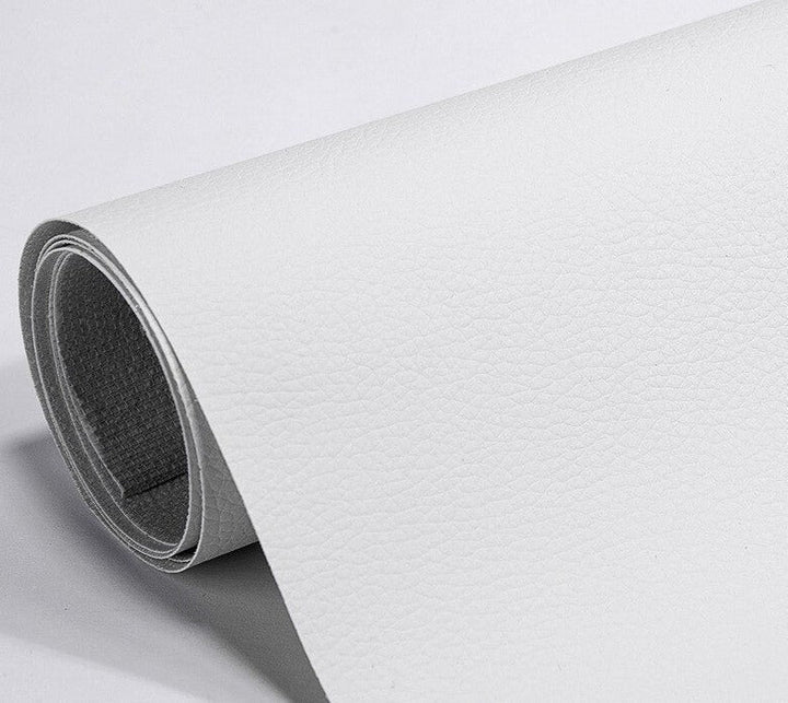 Grey upholstery restoration patch hiding a tear in furniture