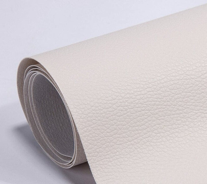Peeling backing paper off self-adhesive upholstery repair patch