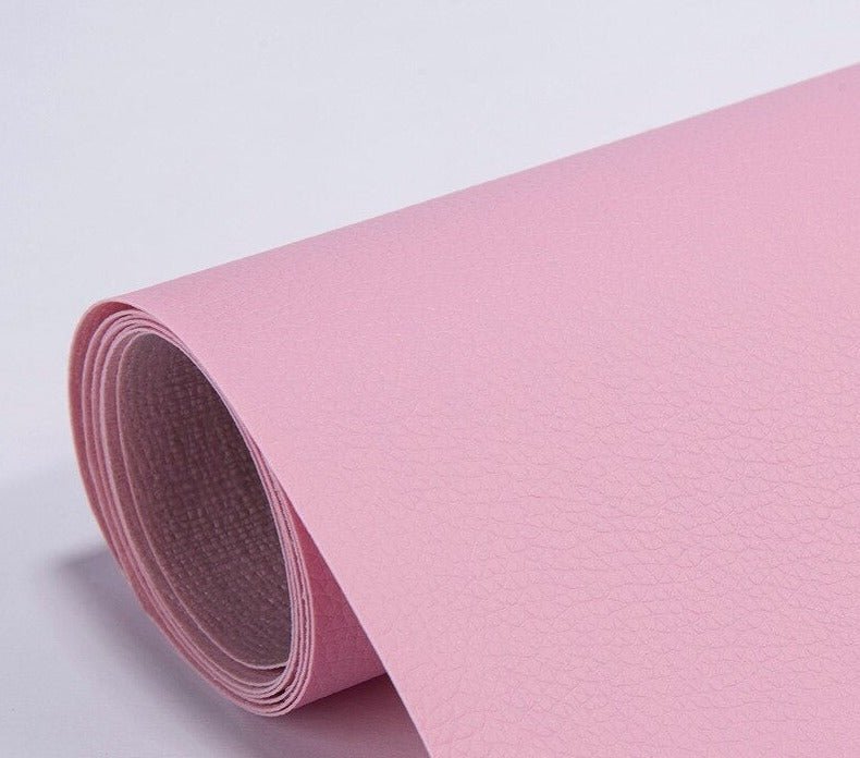 Self-adhesive leather patch applied to a damaged couch cushion