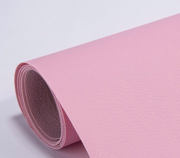 Self-adhesive leather patch applied to a damaged couch cushion
