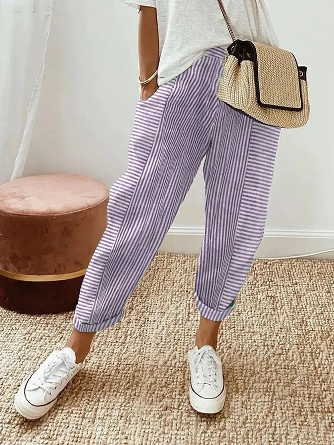 Woman wearing purple striped relaxed trousers with casual footwear