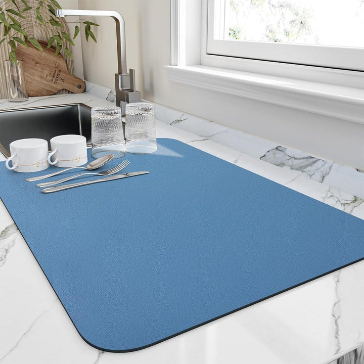 Blue quick dry kitchen dish mat displayed on a white kitchen counter