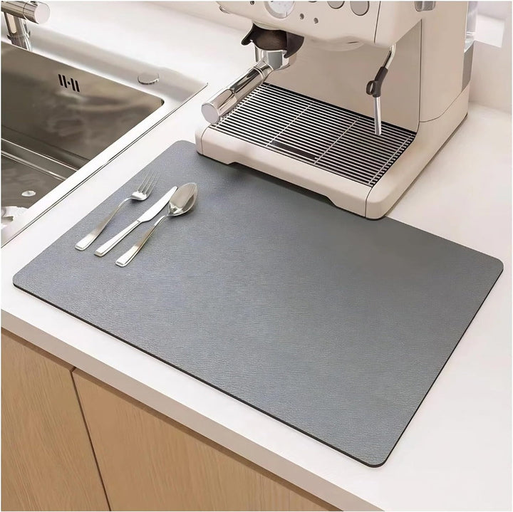 Gray quick dry kitchen dish mat positioned beneath a coffee maker on a counter