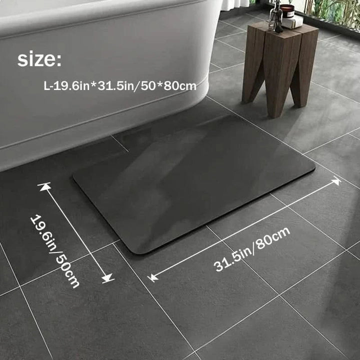 Dark gray rectangular quick-dry diatomite bath mat in size 50x80 cm displayed on a stylish tiled bathroom floor.