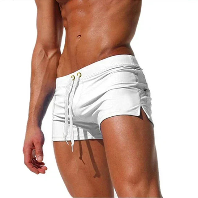 Model wearing white quick-dry swim shorts with adjustable drawstring waistband