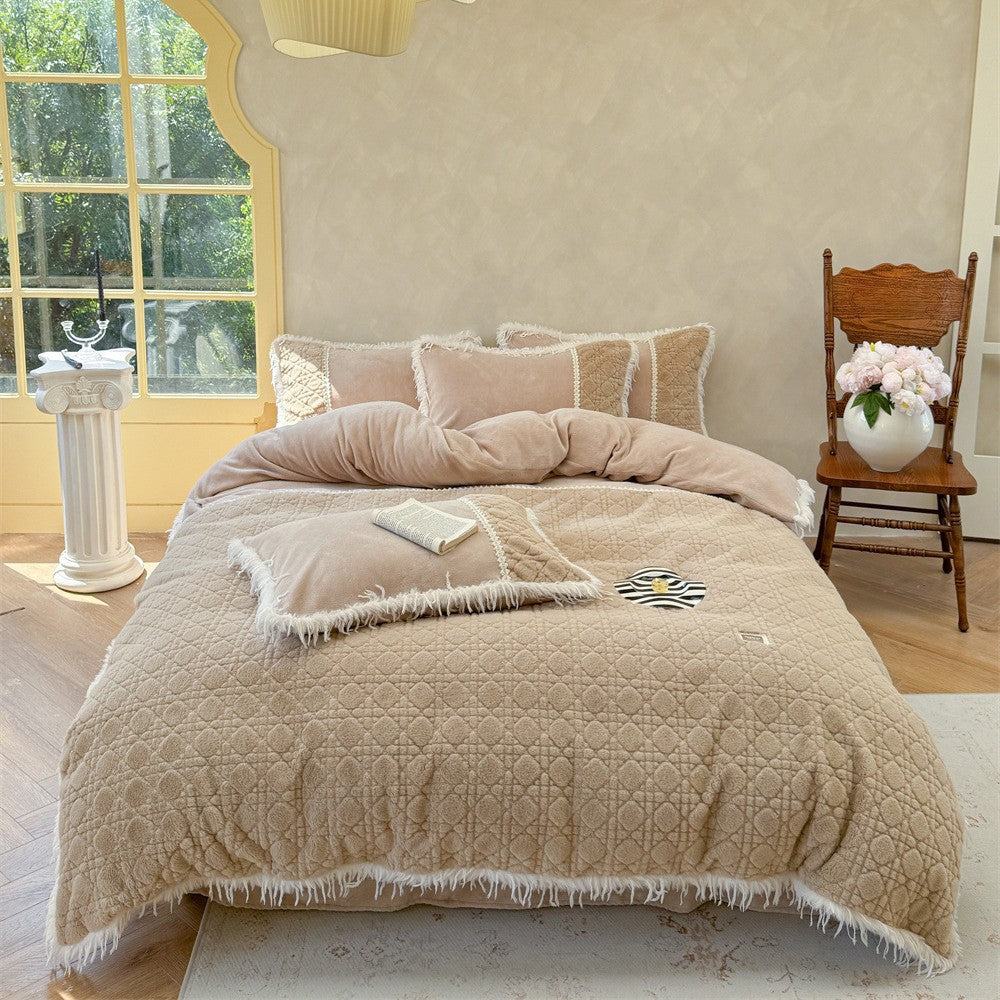 Coffee brown quilted bedding set with fringe trim and coordinated pillows in a cozy interior