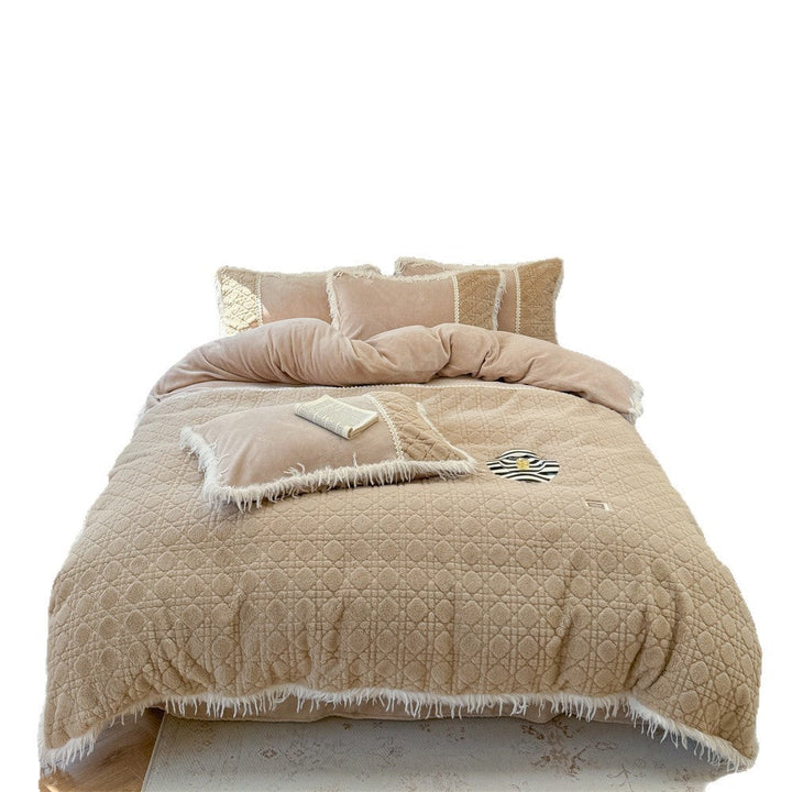 Complete quilted bedding set with decorative pillows and fringe accents