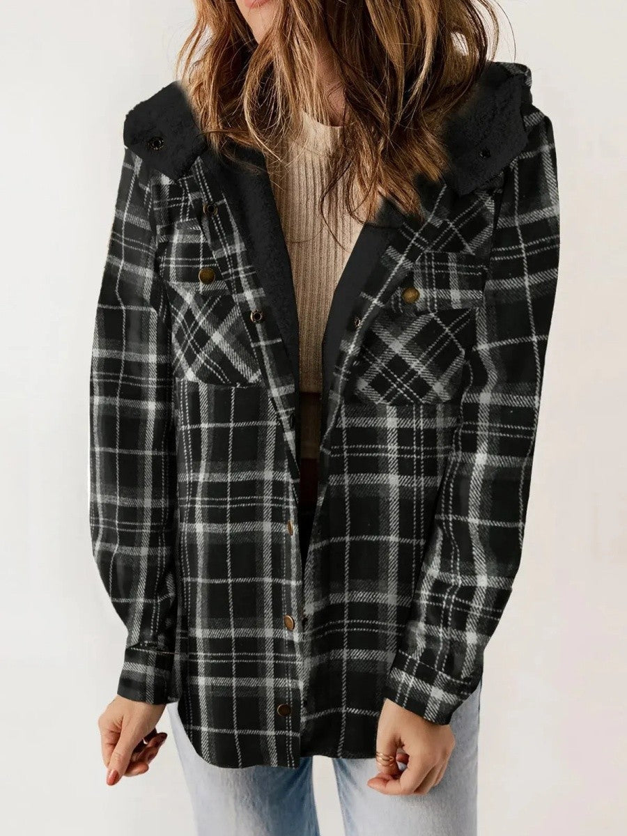 Woman wearing a black hooded plaid jacket with chest pockets