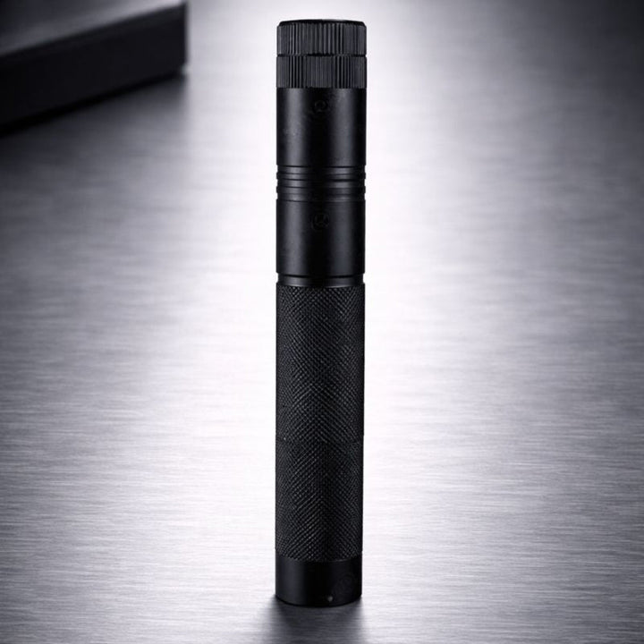 Compact handheld black laser pointer tool viewed vertically