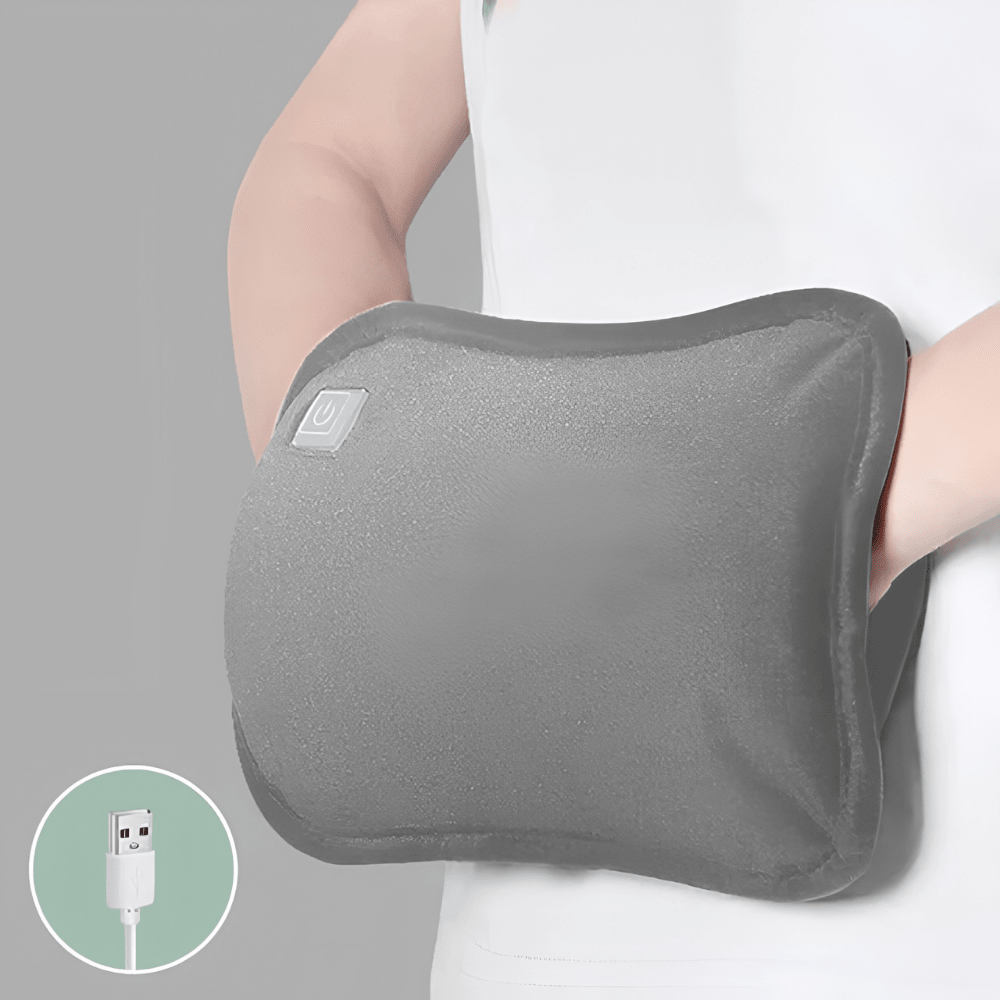 Gray rechargeable USB hand warmer pouch held against clothing with USB cable inset