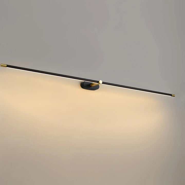 Black and gold rechargeable linear LED wall light glowing against a neutral wall