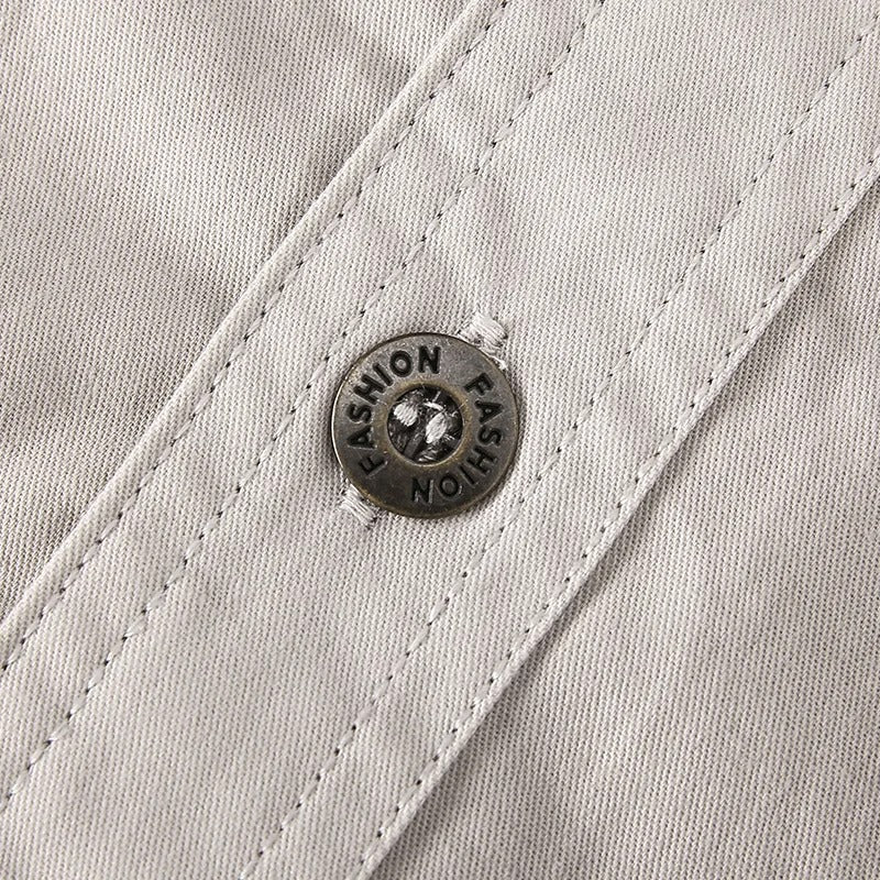 Close-up of button closure and chest pocket on men's utility shirt