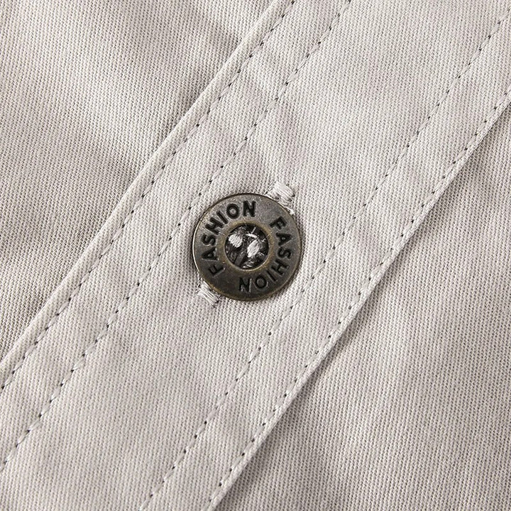 Close-up of button closure and chest pocket on men's utility shirt